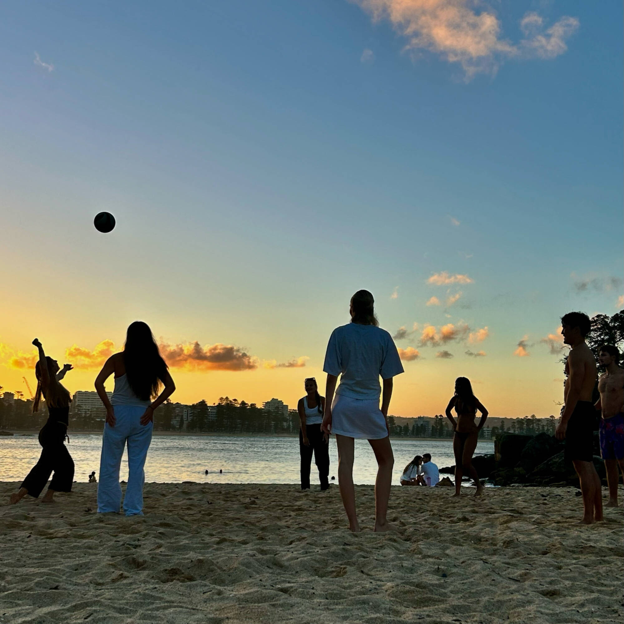 Students playing beach volleyball in Australia